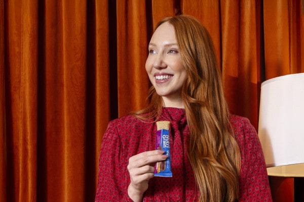 a lady snacking on a Nutri-Grain bar